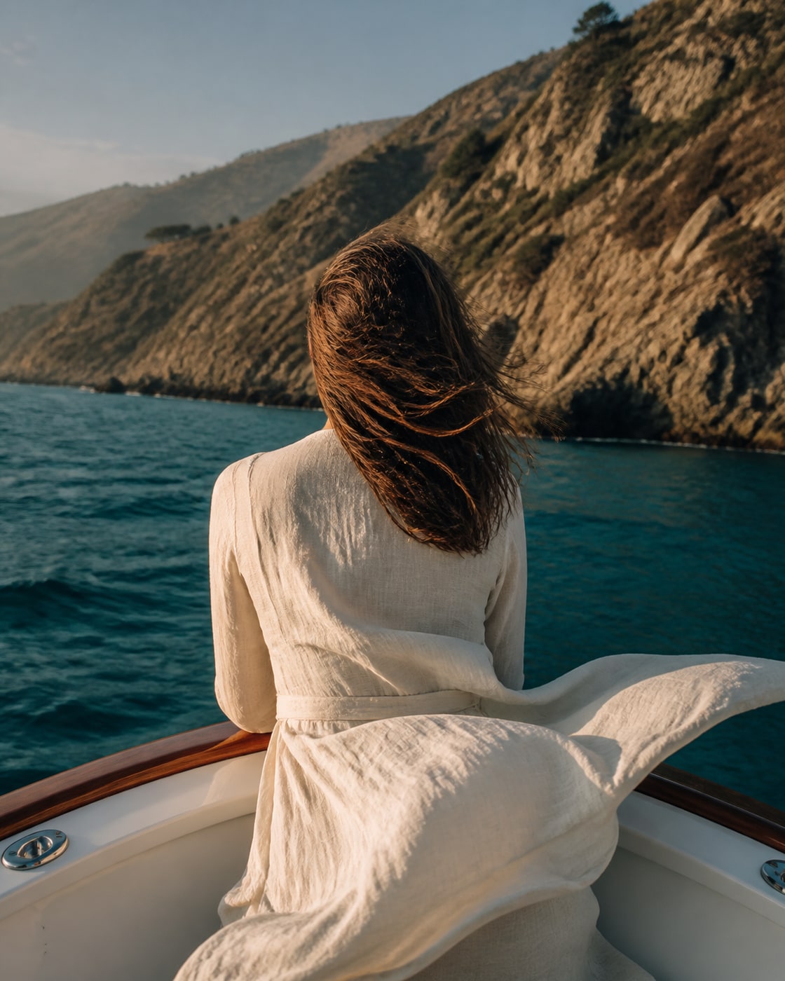 A fictional back-facing portrait near the California shoreline at golden hour