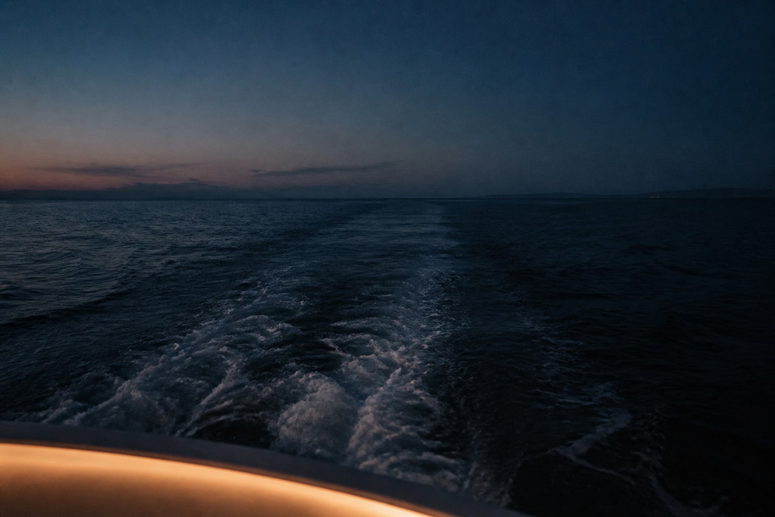 A fictional coastal wake fading into evening light in Southern California